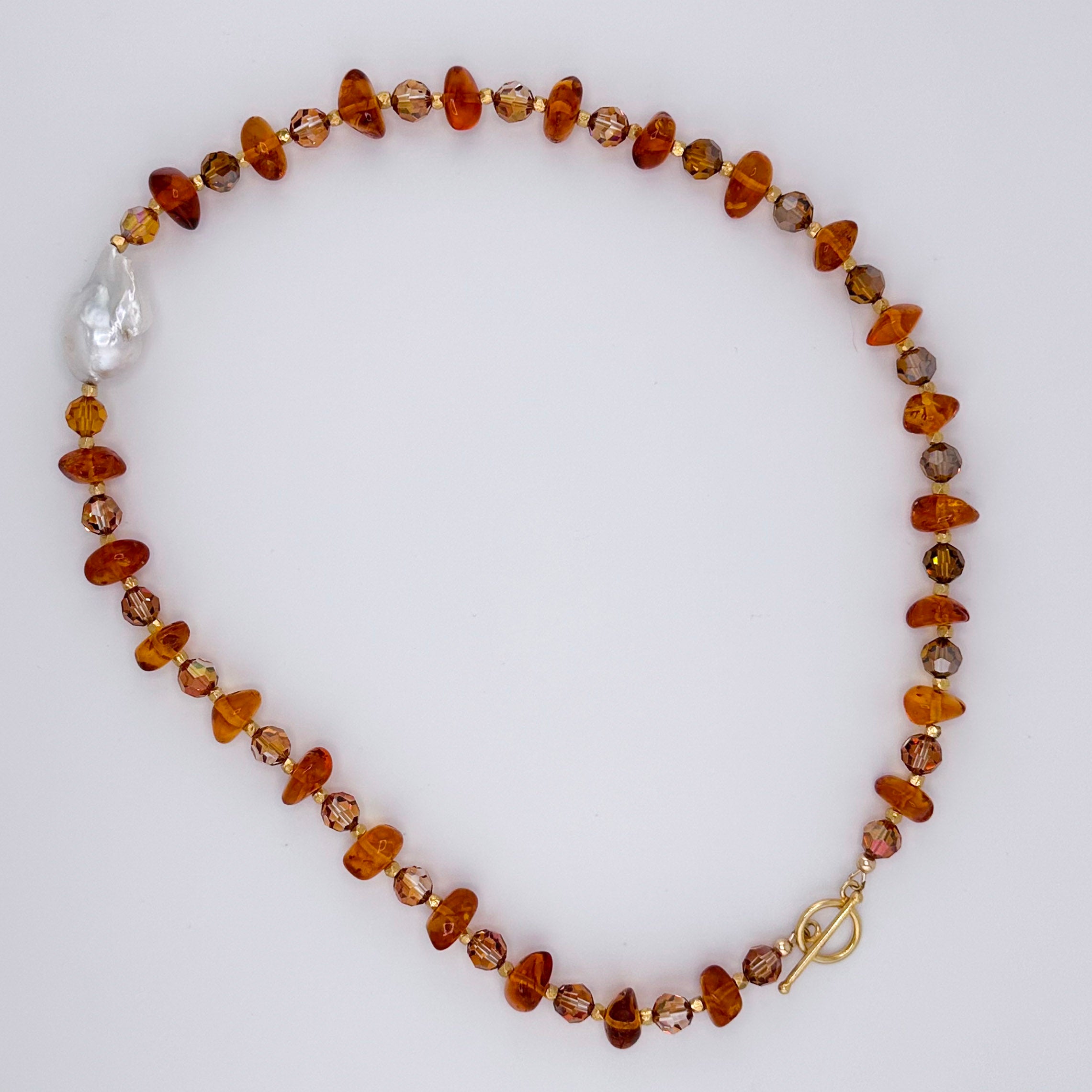 Amber, Pearl, Swarovski Crystal, and 22K Gold Vermeil Necklace flatlay on white background