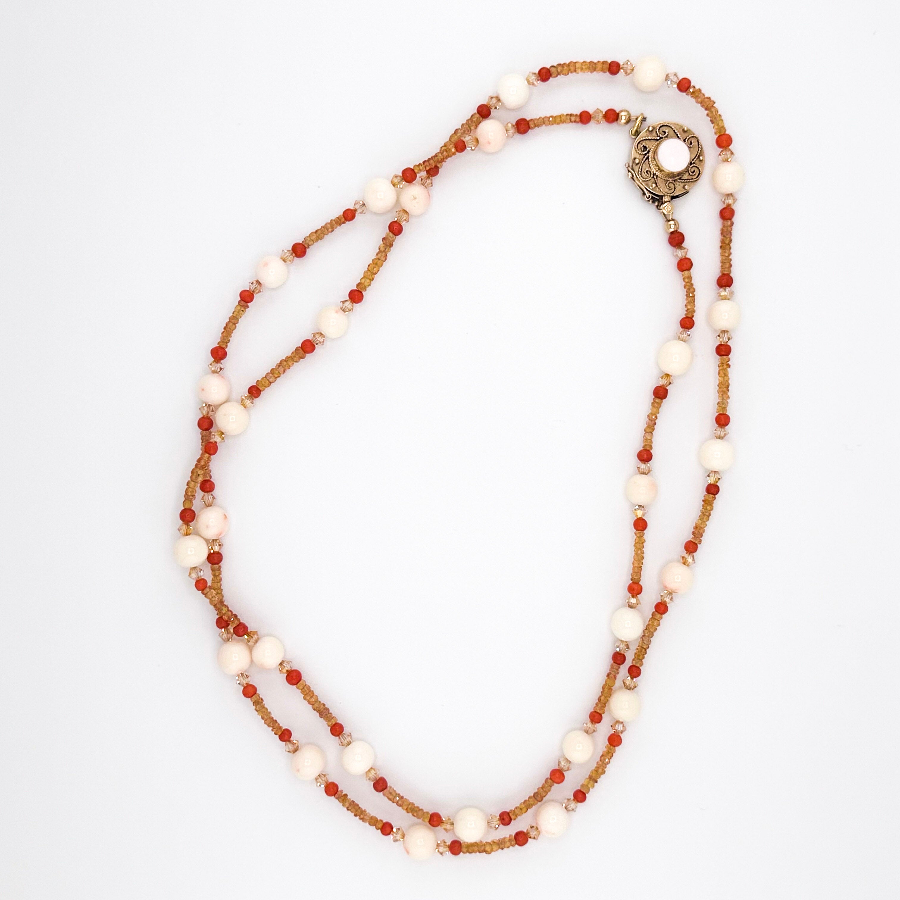 Angel Skin Coral, Sapphire, Coral, Swarovski Crystal, and 14K Gold Necklace flatlay on white background
