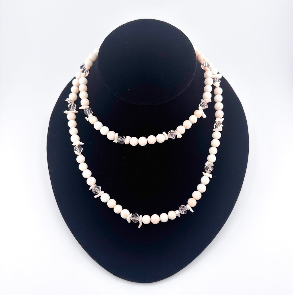 Angel Skin Coral, Swarovski Crystal, and 22K Gold Vermeil Necklace on black bust