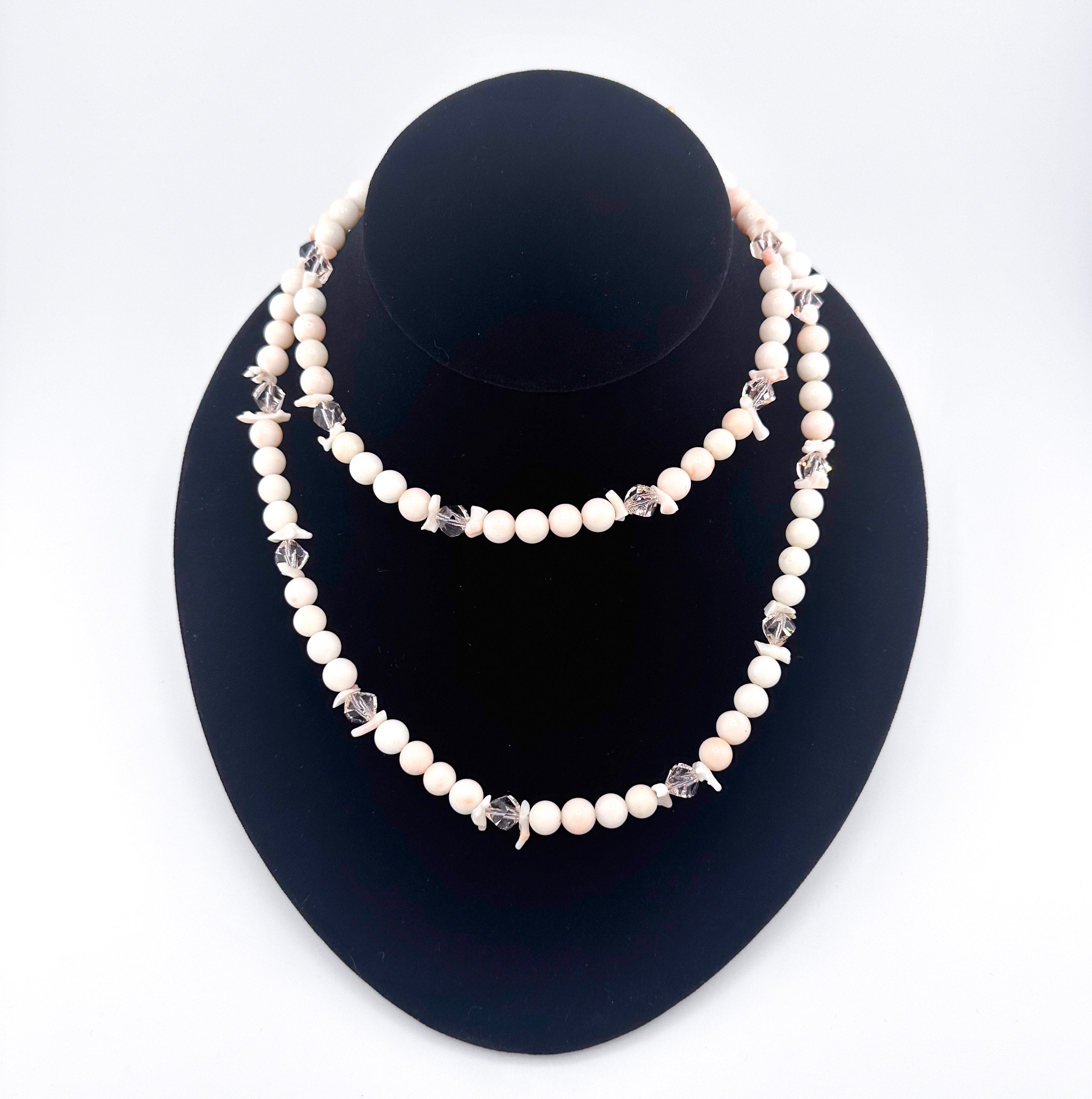 Angel Skin Coral, Swarovski Crystal, and 22K Gold Vermeil Necklace on black bust