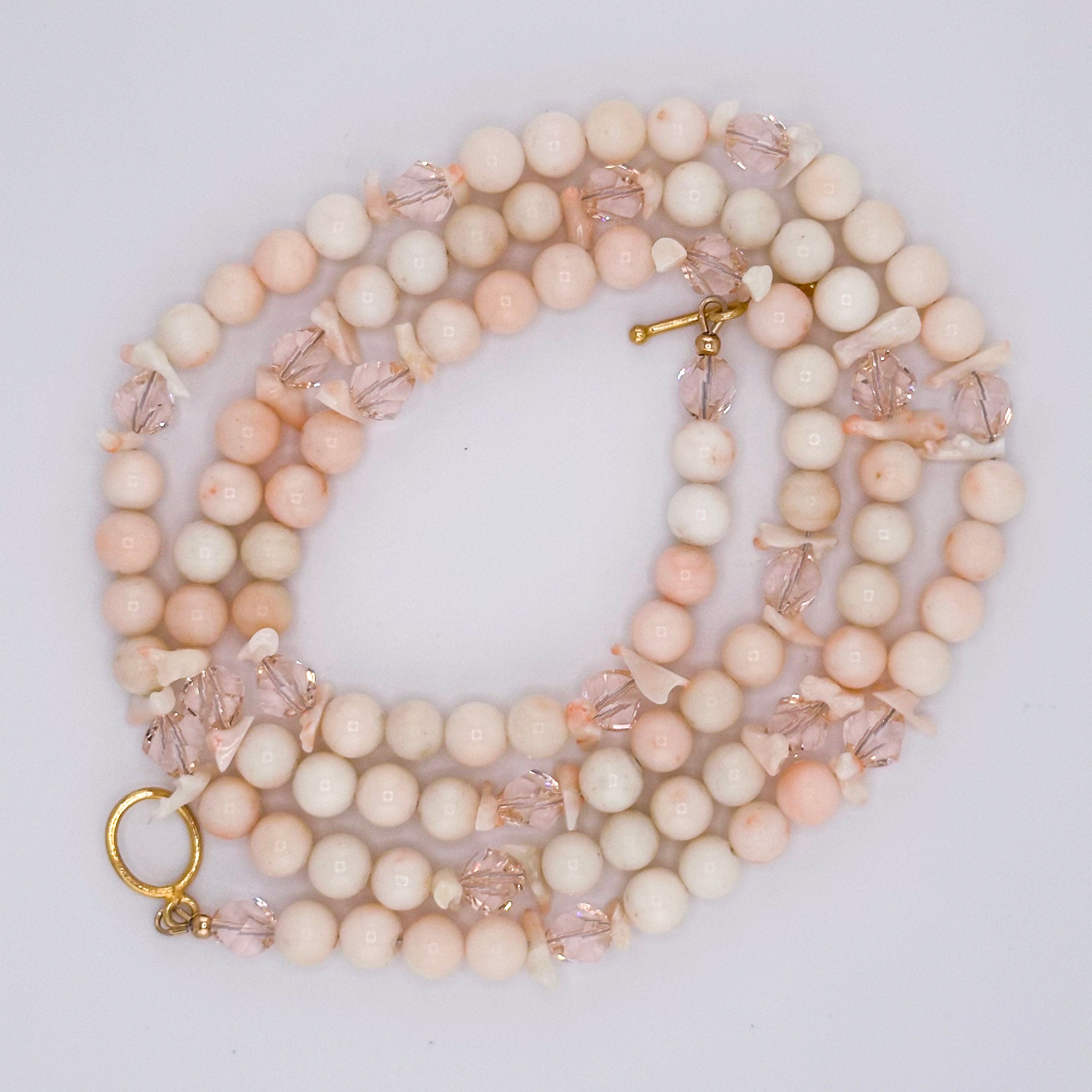 Angel Skin Coral, Swarovski Crystal, and 22K Gold Vermeil Necklace flatlay on white background