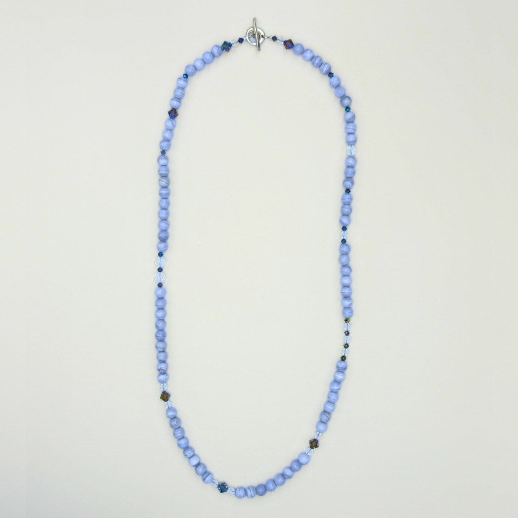 Blue Lace Agate, Swarovski Crystal, and Sterling Silver Necklace flatlay on white background