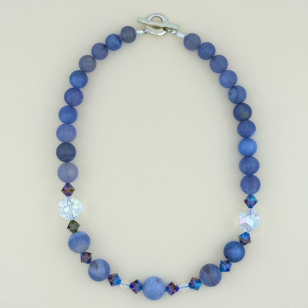 Blue Lace Agate, Swarovski Crystal, and Sterling Silver Necklace flatlay on white background