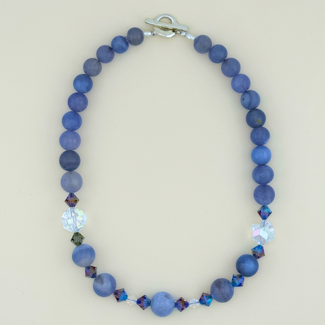 Blue Lace Agate, Swarovski Crystal, and Sterling Silver Necklace flatlay on white background