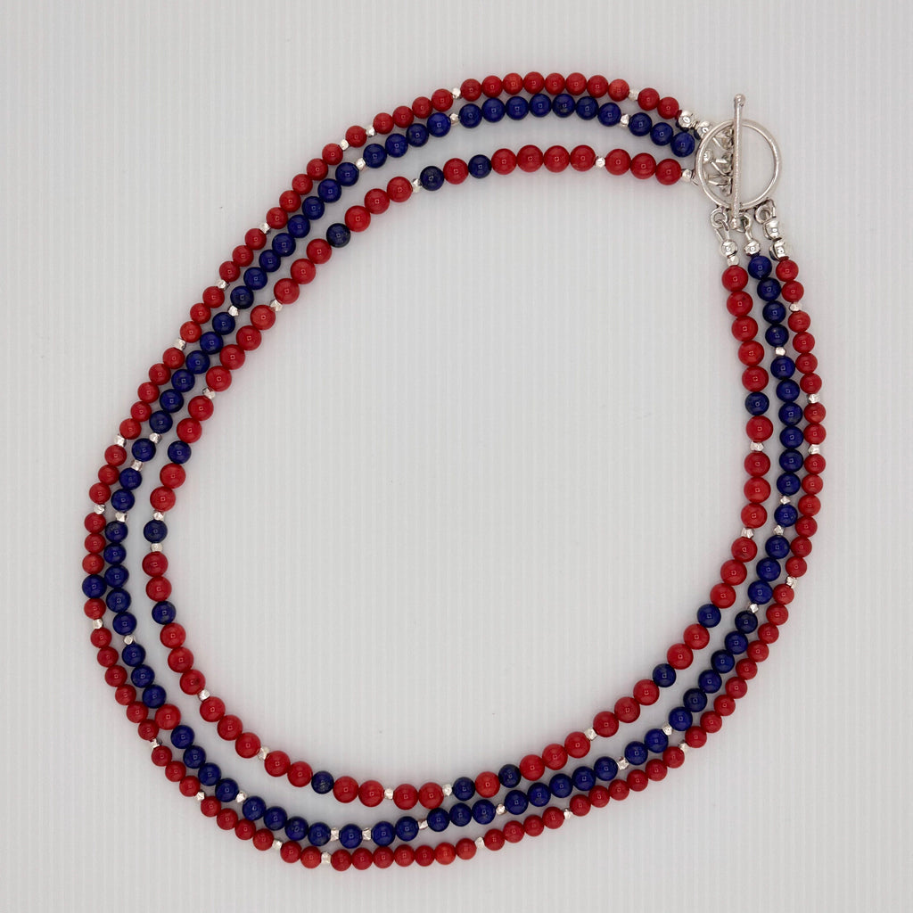 Coral, Lapis, and Sterling Silver Necklace flatlay on white background