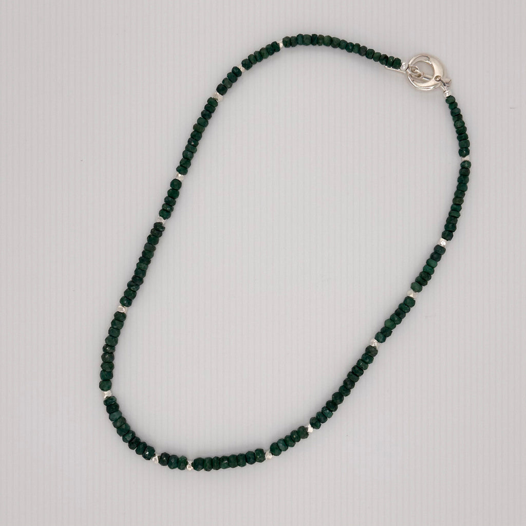 Emerald and Sterling Silver Necklace flatlay on white background