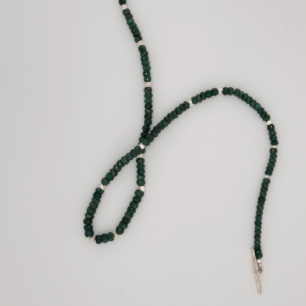 Emerald and Sterling Silver Necklace closeup on white background