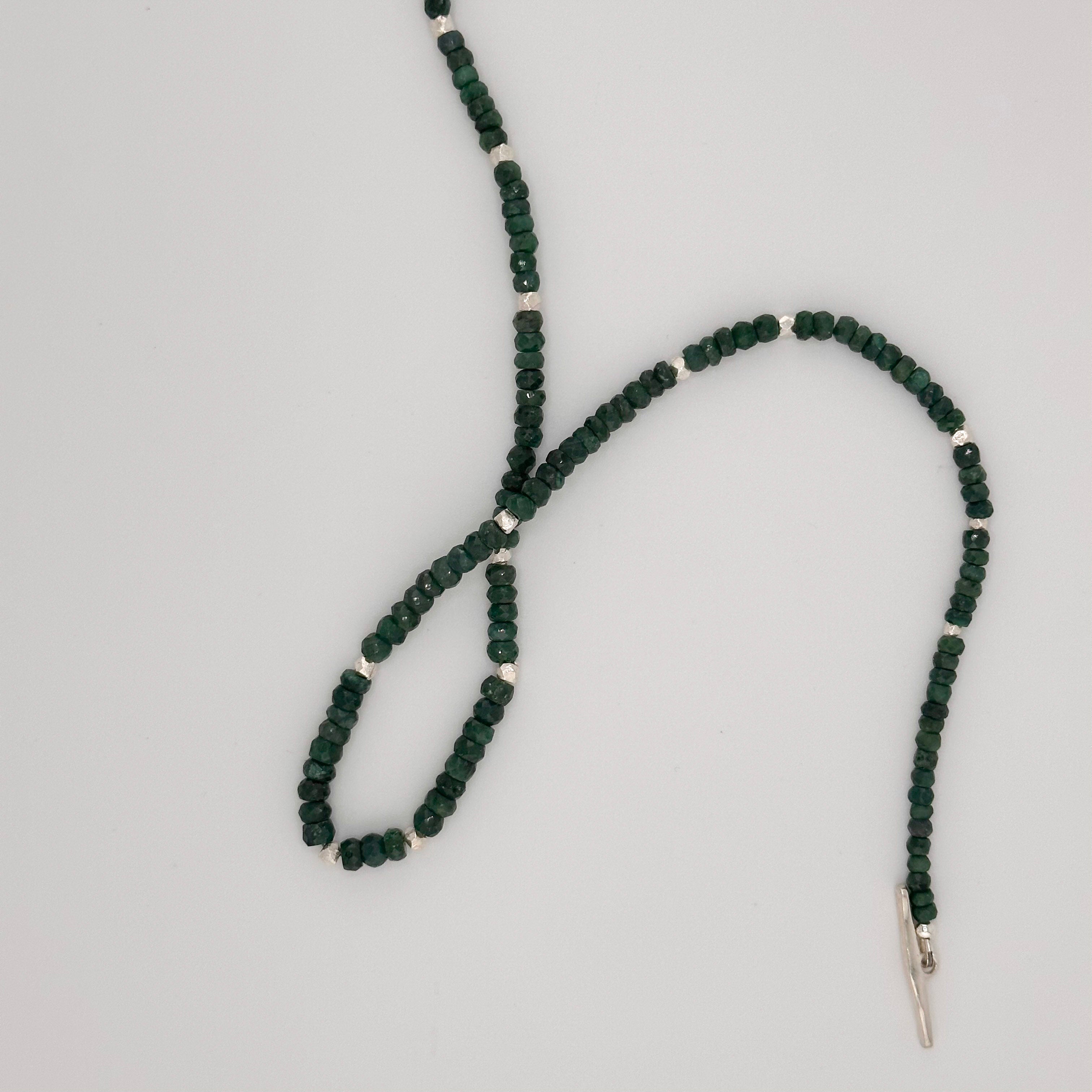 Emerald and Sterling Silver Necklace closeup on white background