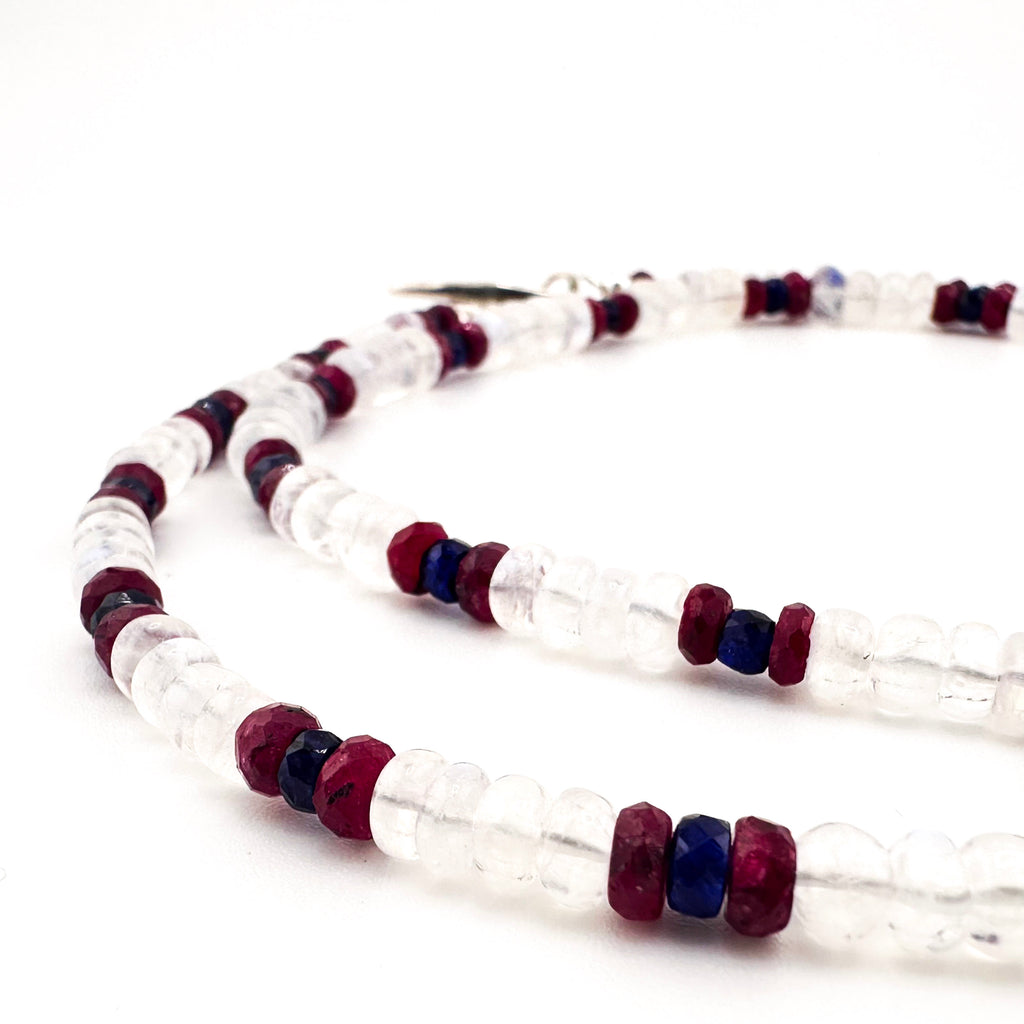 Moonstone, Ruby, Sapphire, and Sterling Silver Necklace closeup on white background