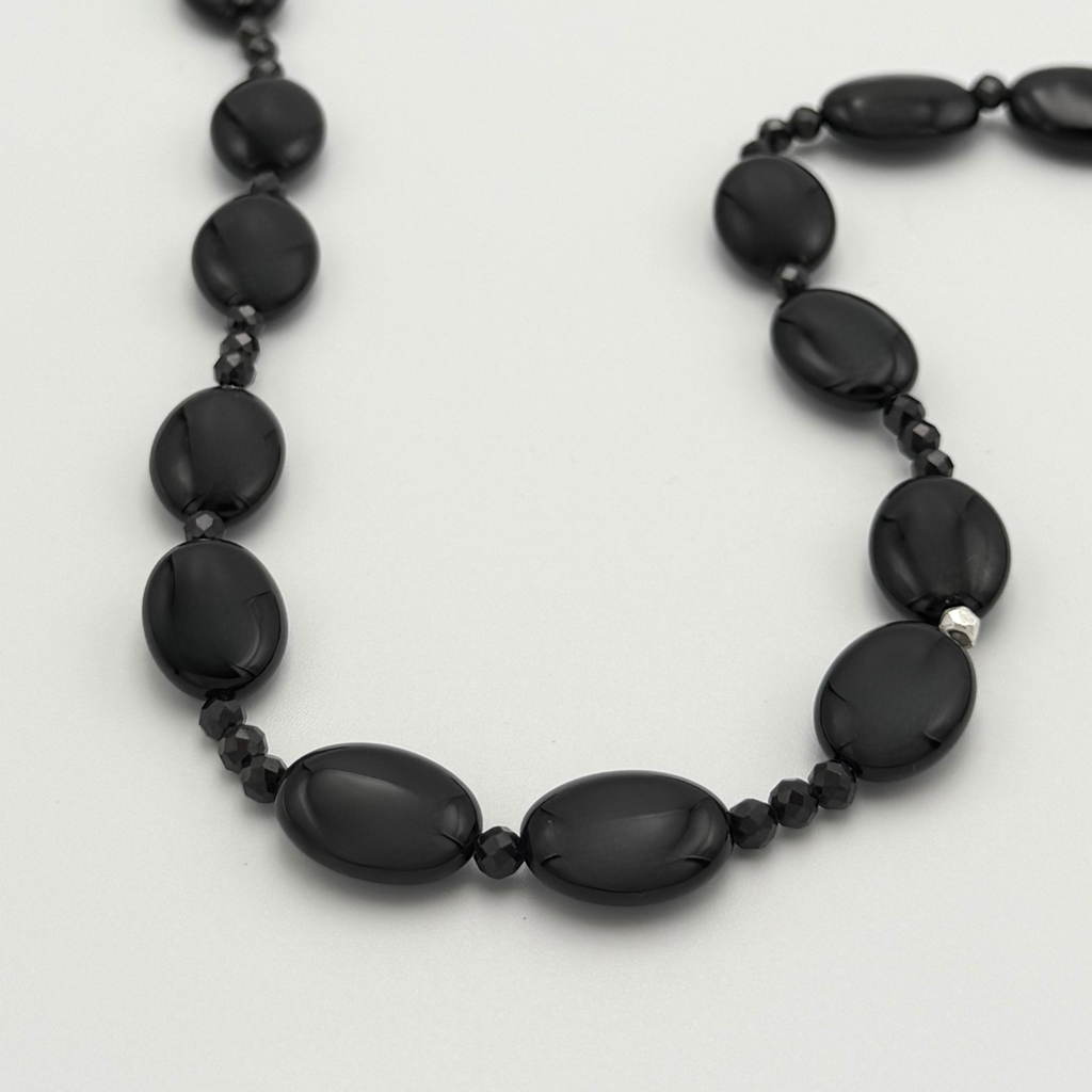 Onyx, Spinel, and Sterling Silver Necklace closeup on white background