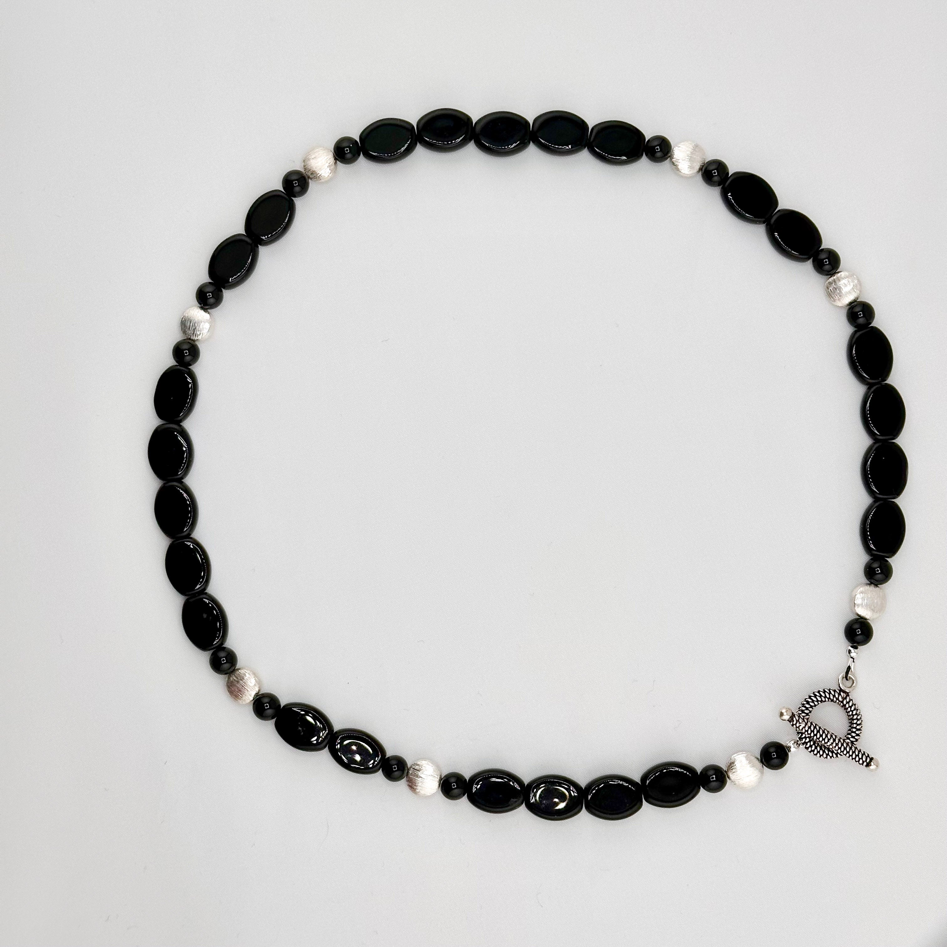 Onyx and Sterling Silver Necklace flatlay on white background