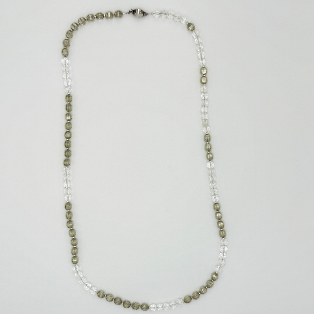 Quartz, Crystal, and Sterling Silver Necklace flatlay on white background