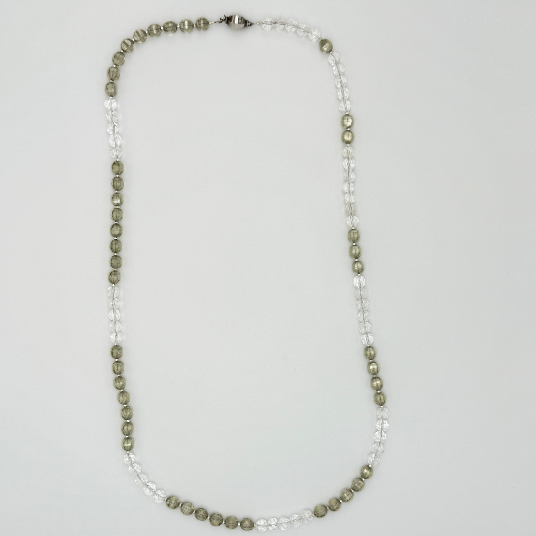 Quartz, Crystal, and Sterling Silver Necklace flatlay on white background
