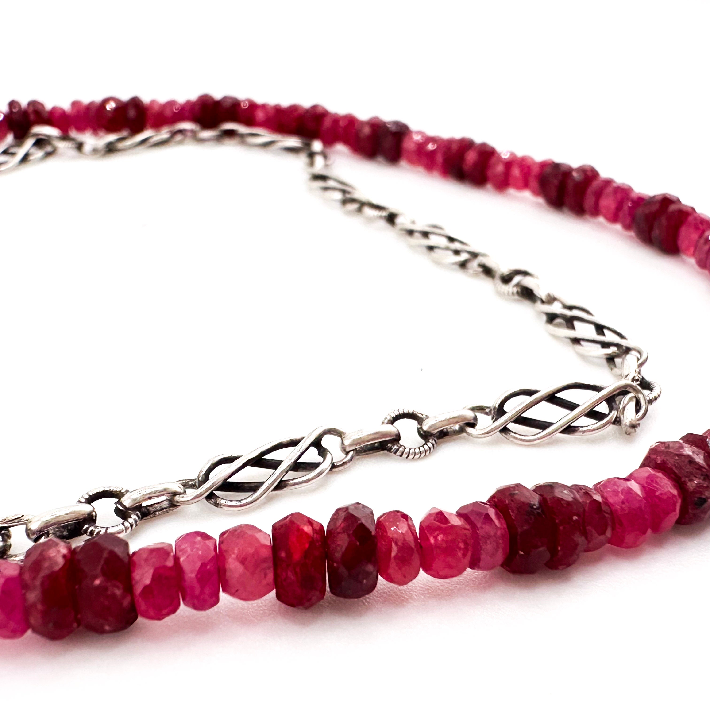 Ruby, Sapphire, and Sterling Silver Necklace closeup on white background