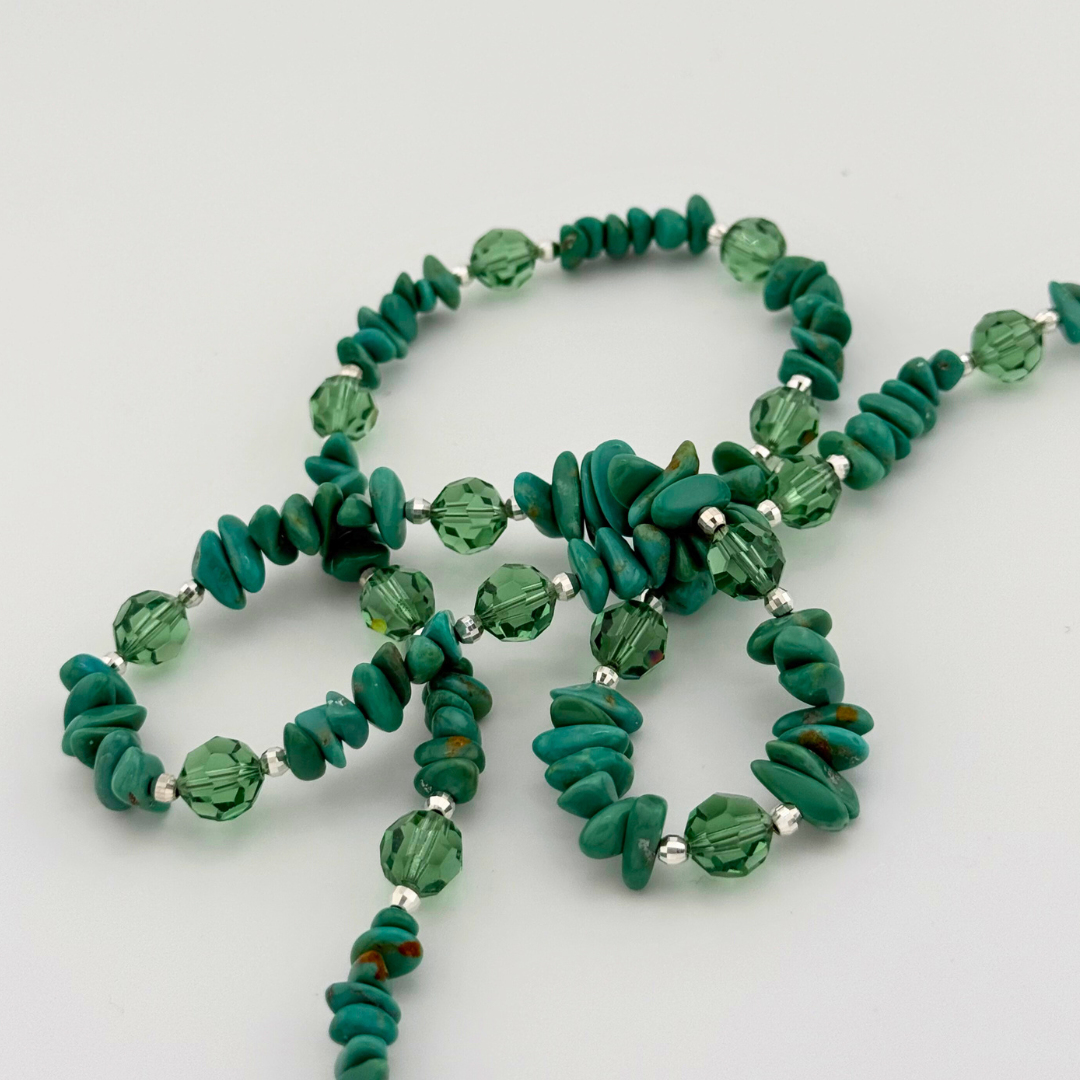 Turquoise, Swarovski Crystal, and Sterling Silver Necklace close-up on white background