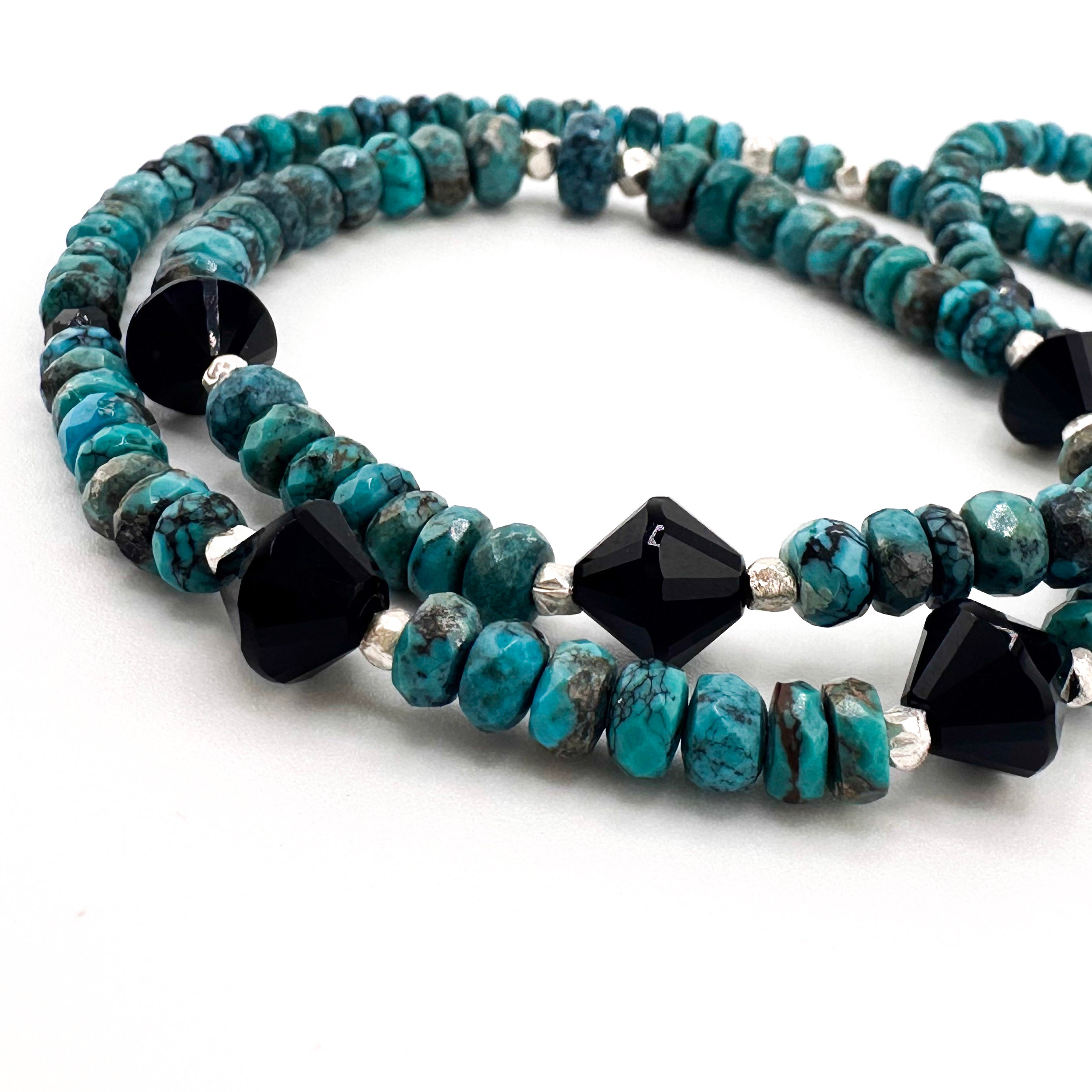 Turquoise, Spinel, Onyx, and Sterling Silver Necklace close-up on white background