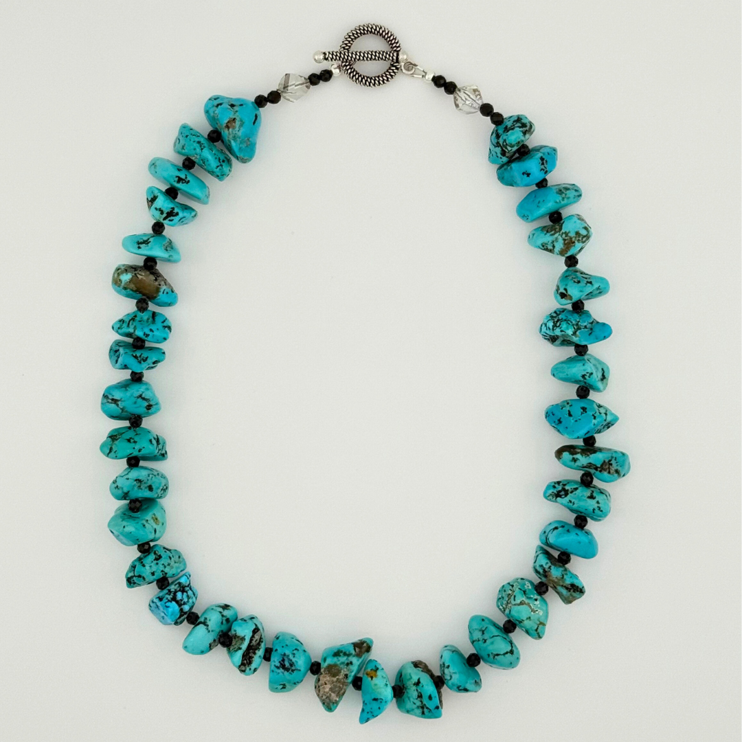 Turquoise, Spinel, Quartz, and Sterling Silver Necklace flatlay on white background