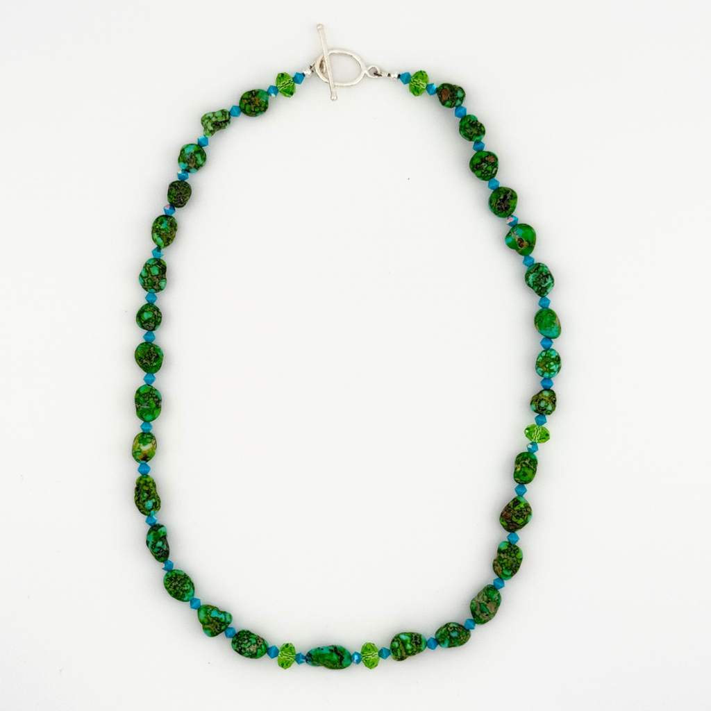 Turquoise, Swarovski Crystal, and Sterling Silver Necklace flatlay on white background
