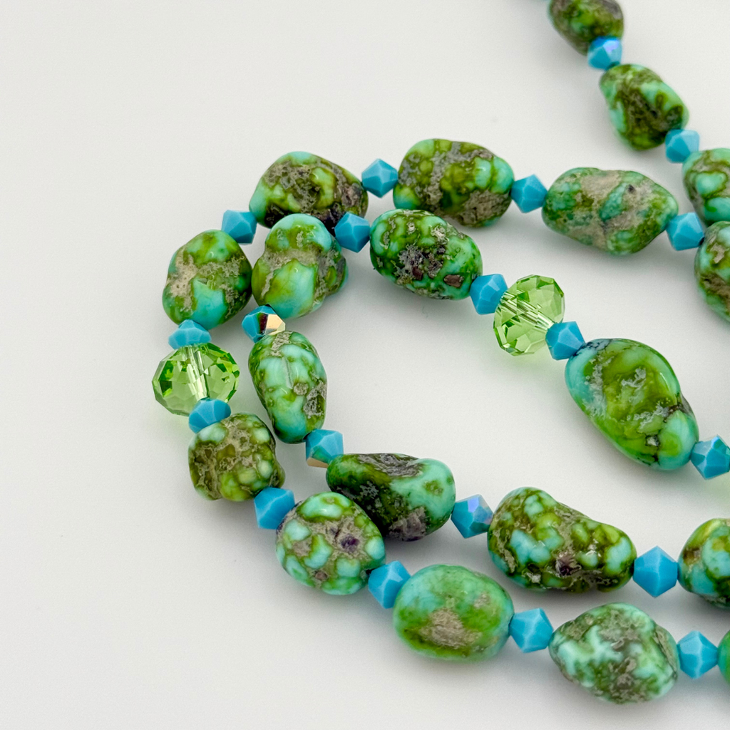 Turquoise, Swarovski Crystal, and Sterling Silver Necklace close-up on white background