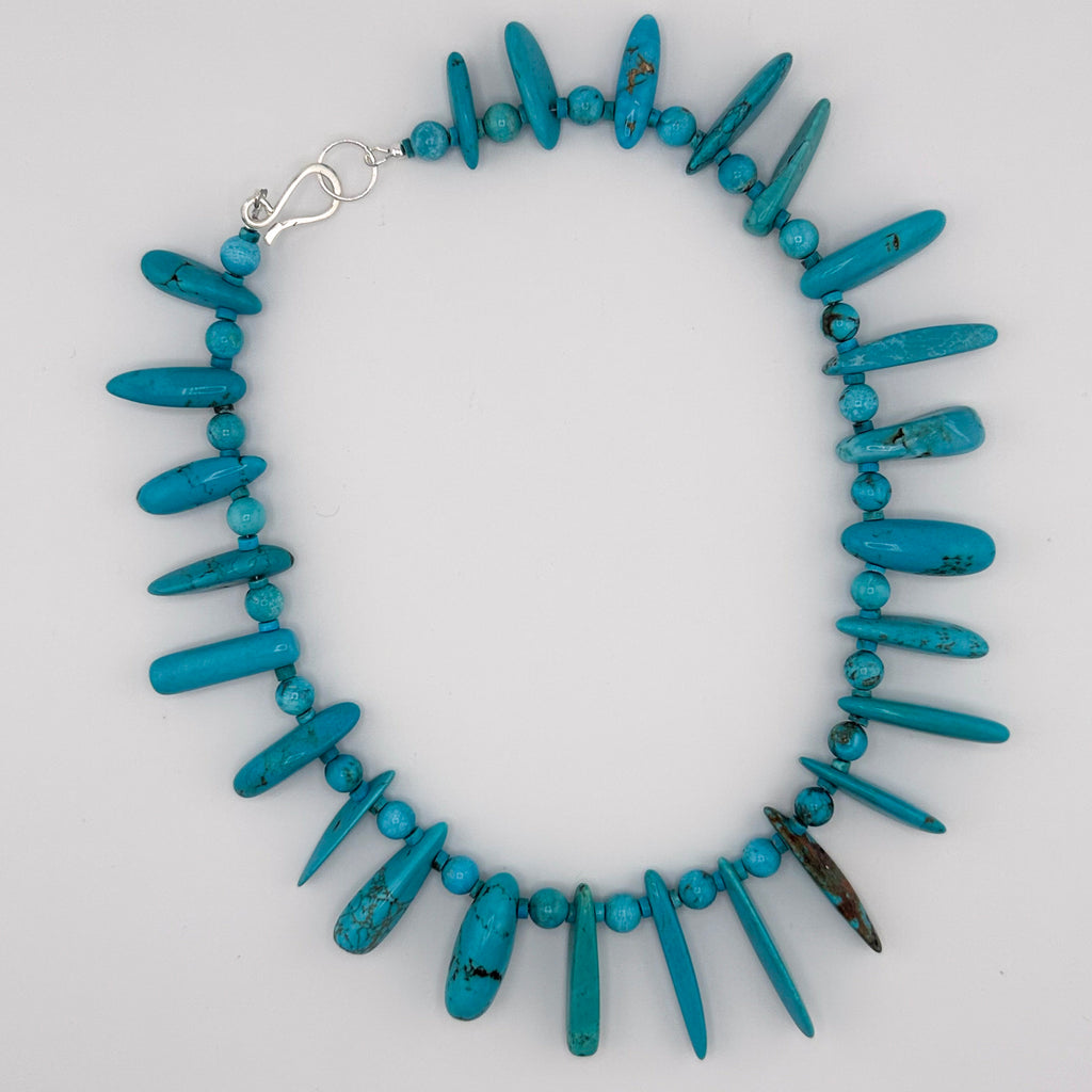 Turquoise and Sterling Silver Necklace flatlay on white background