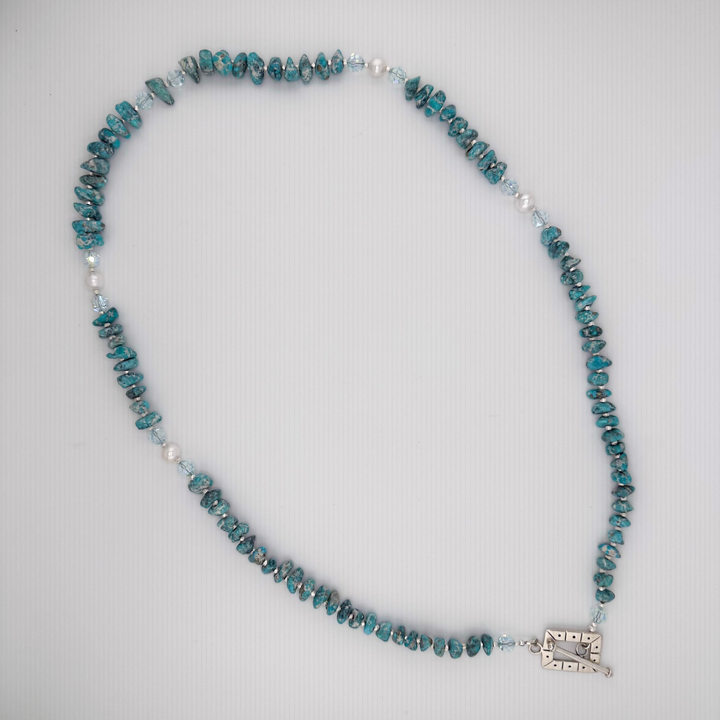 Turquoise, Pearl, Swarovski Crystal, and Sterling Silver Necklace flatlay on white background