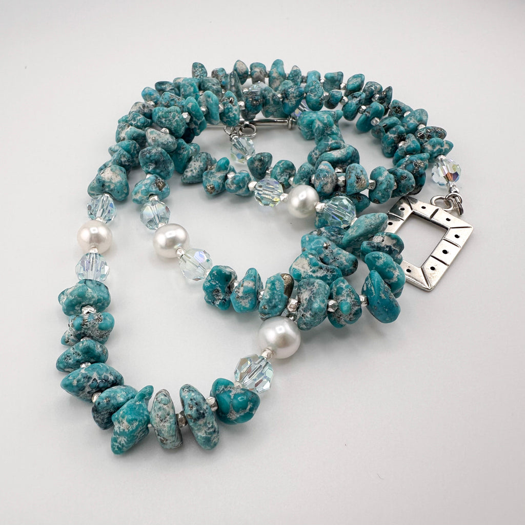 Turquoise, Pearl, Swarovski Crystal, and Sterling Silver Necklace close-up on white background