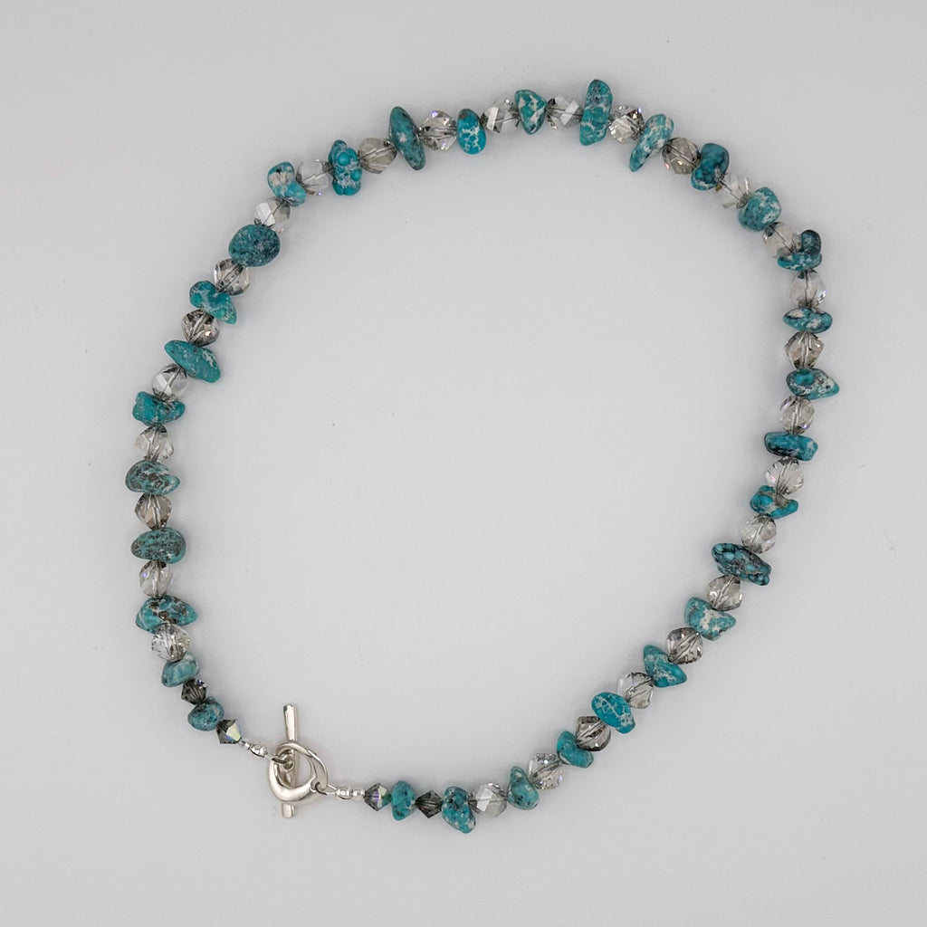 Turquoise, Quartz, Swarovski Crystal, Hematite, and Sterling Silver Necklace flatlay on white background