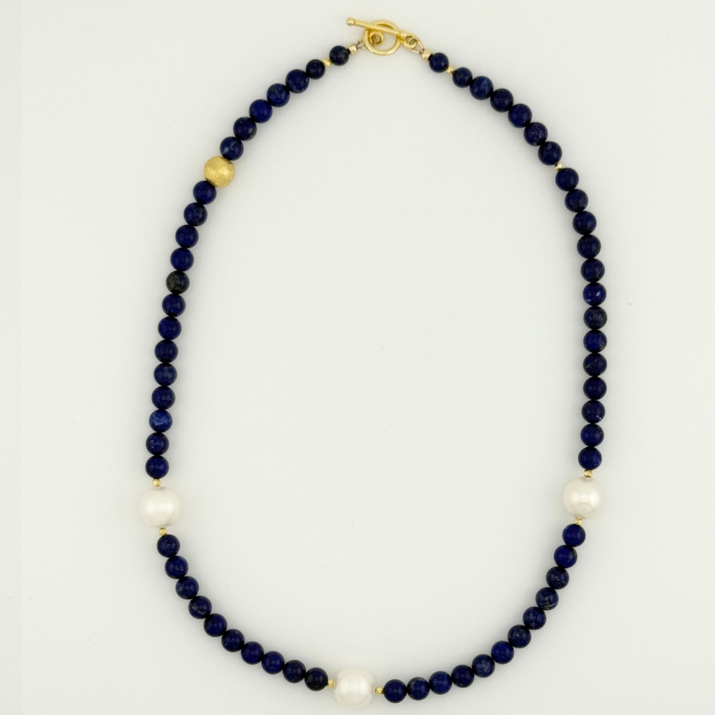 Lapis, Pearl, and 22K Gold Vermeil flatlay on white background