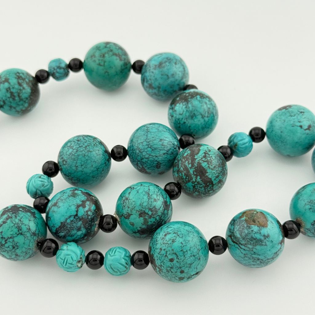 Turquoise, Onyx, and Silver Necklace close-up on white background